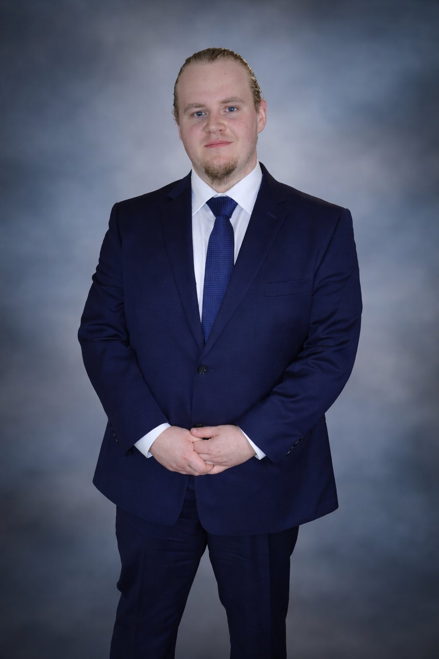 Tyler Mobus in a navy suit